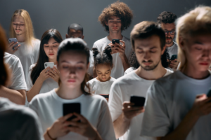 group of people wearing all white on their phones