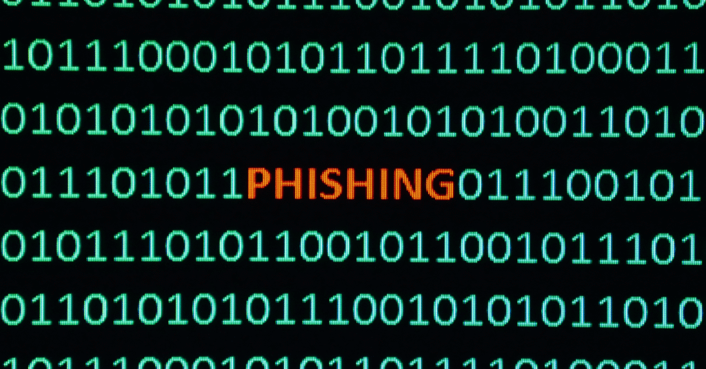 The word “PHISHING” in red letters hidden within green binary code on a black background, symbolizing online scams disguised as legitimate digital activity.