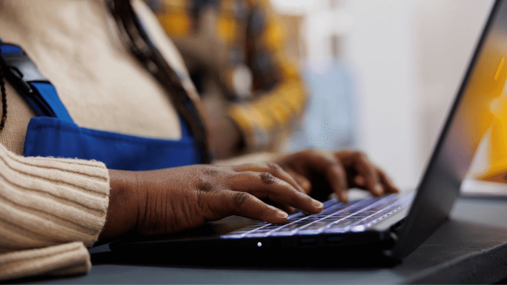 Woman typing on her laptop in a modern office.