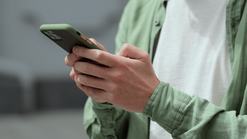 Person holding a smartphone and reading a website message or inquiry