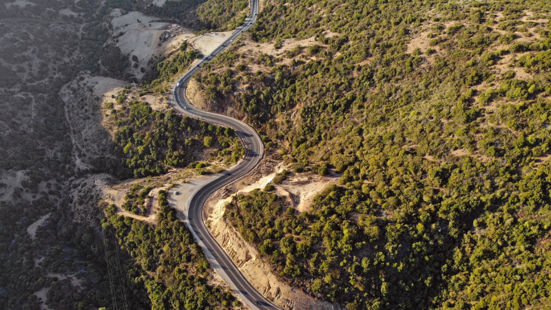 A winding road through a mountainous landscape, representing setting a clear direction before beginning audience research