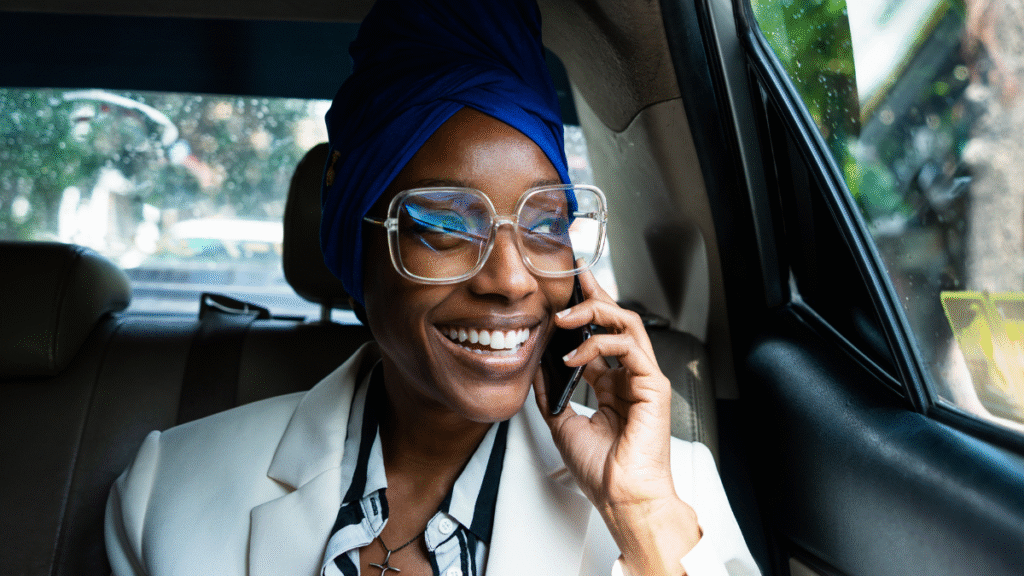 Entrepreneur taking a business call on mobile phone while traveling in a car