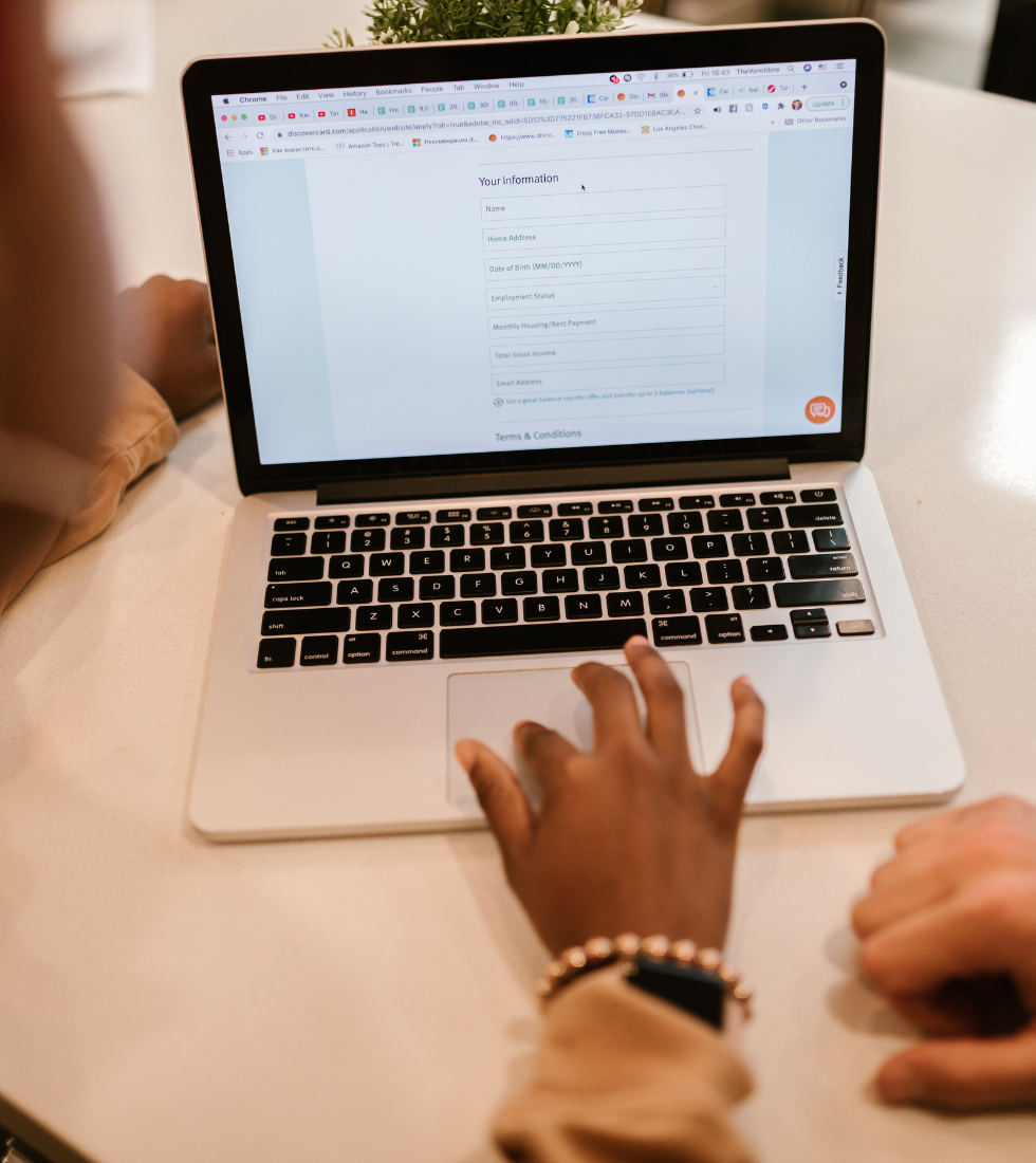 person filling out contact form in a bright office setting
